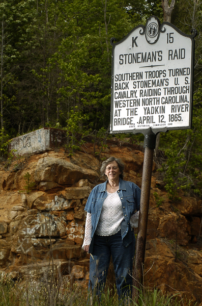 Brownlee stands beside historic marker